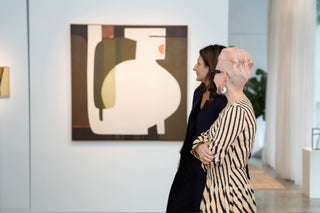 Anna Kiousis owner of Kasmiri and Sophie Vander owner of Curatorial+Co. in art gallery looking at painting by Leonie Barton. 