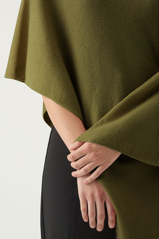 100% Cashmere Poncho in Olive Green worn by woman with black pants