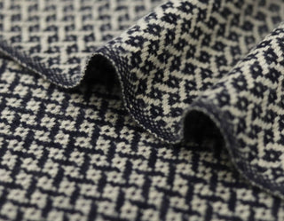 Close-up of a textured fabric with a black and white pattern
