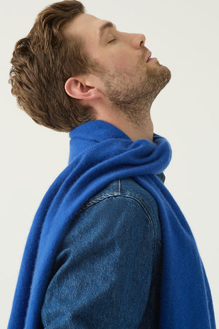 Man wearing a blue sweater against a white background