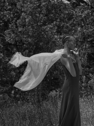 women has a white cashmere scarf around her shoulders