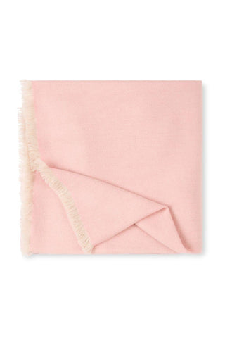 Pink blanket with tassels on a white background