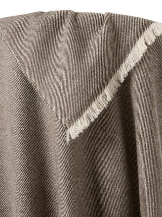 close up of brown cashmere blanket over a chair to show diagonal weave patternl