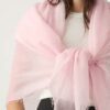woman wears sheer scarf in blush pink tied in the front