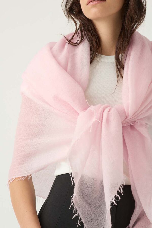 woman wears sheer scarf in blush pink tied in the front